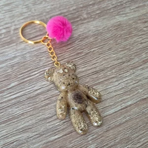 Porte-clés ourson doré avec pompon rose